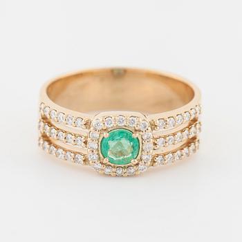 An emerald and brilliant cut diamond ring.