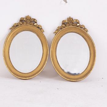 A pair of Gustavian style giltwood and parcel-gilt mirrors from around year 1900.