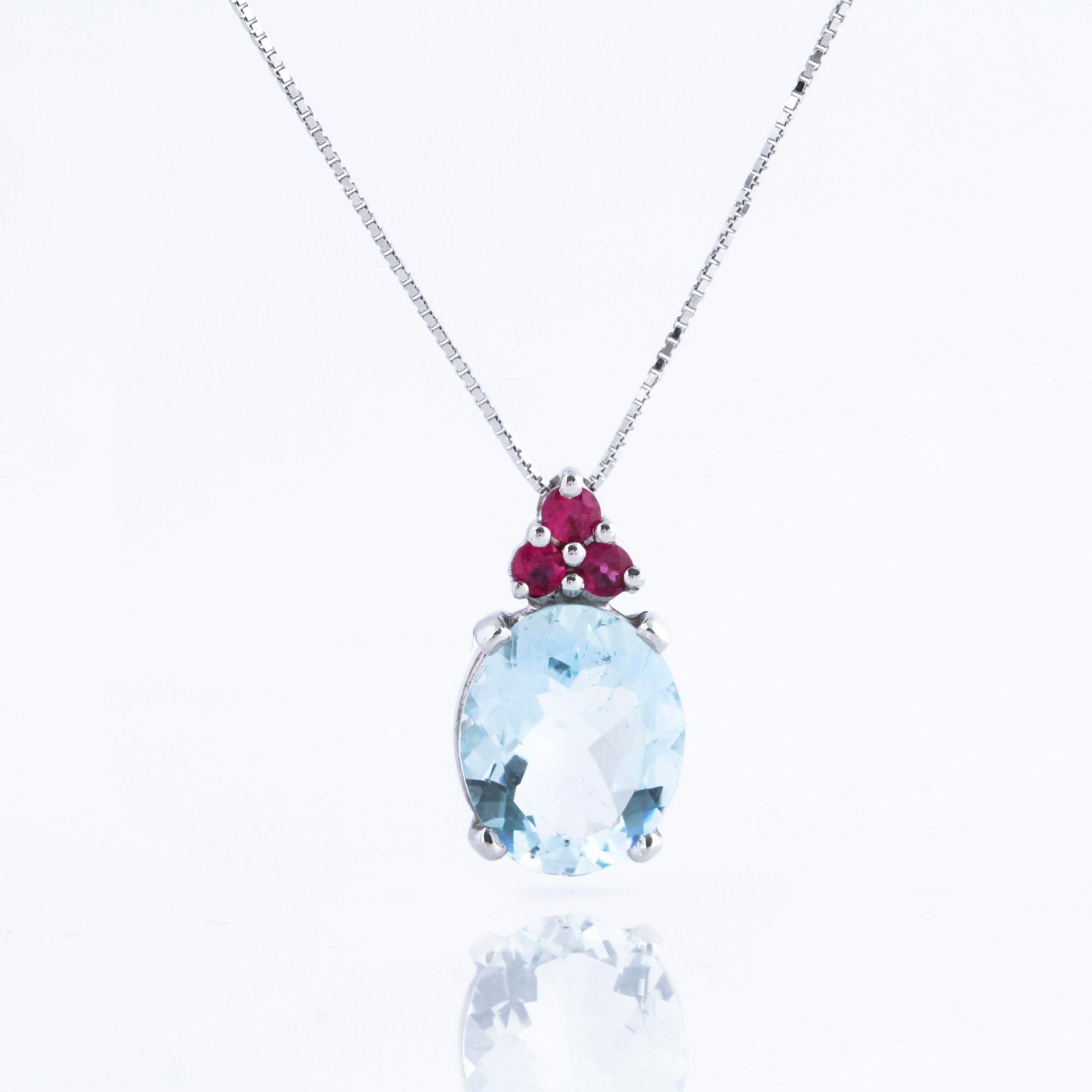 A aquamarine and ruby pendant.
