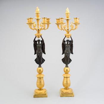 A large pair of first half of the 19th century gilt and patinated bronze five-light candelabra.