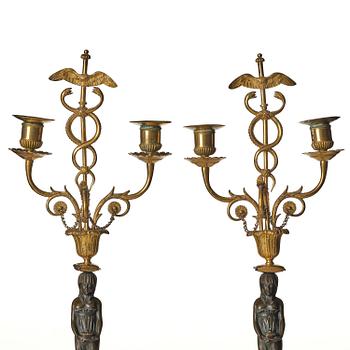 A pair of late Gustavian white marble and bronze candelabra.