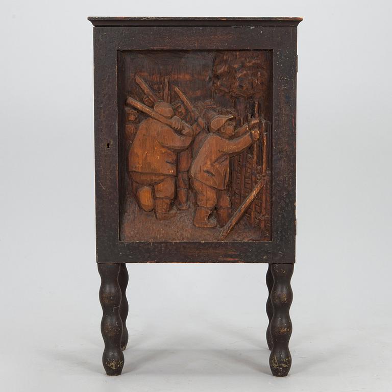 A 1920s cabinet with a relief.