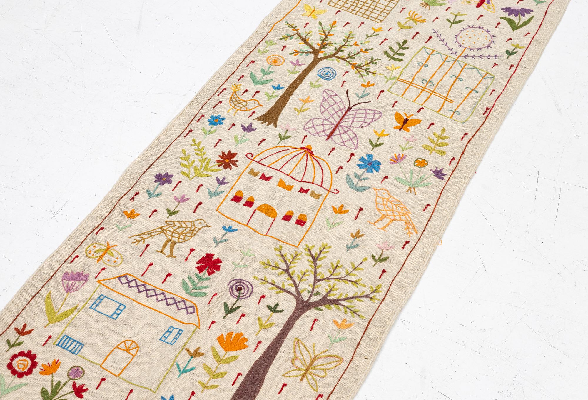 A hand-embroidered kilim runner, c. 300 x 80 cm.