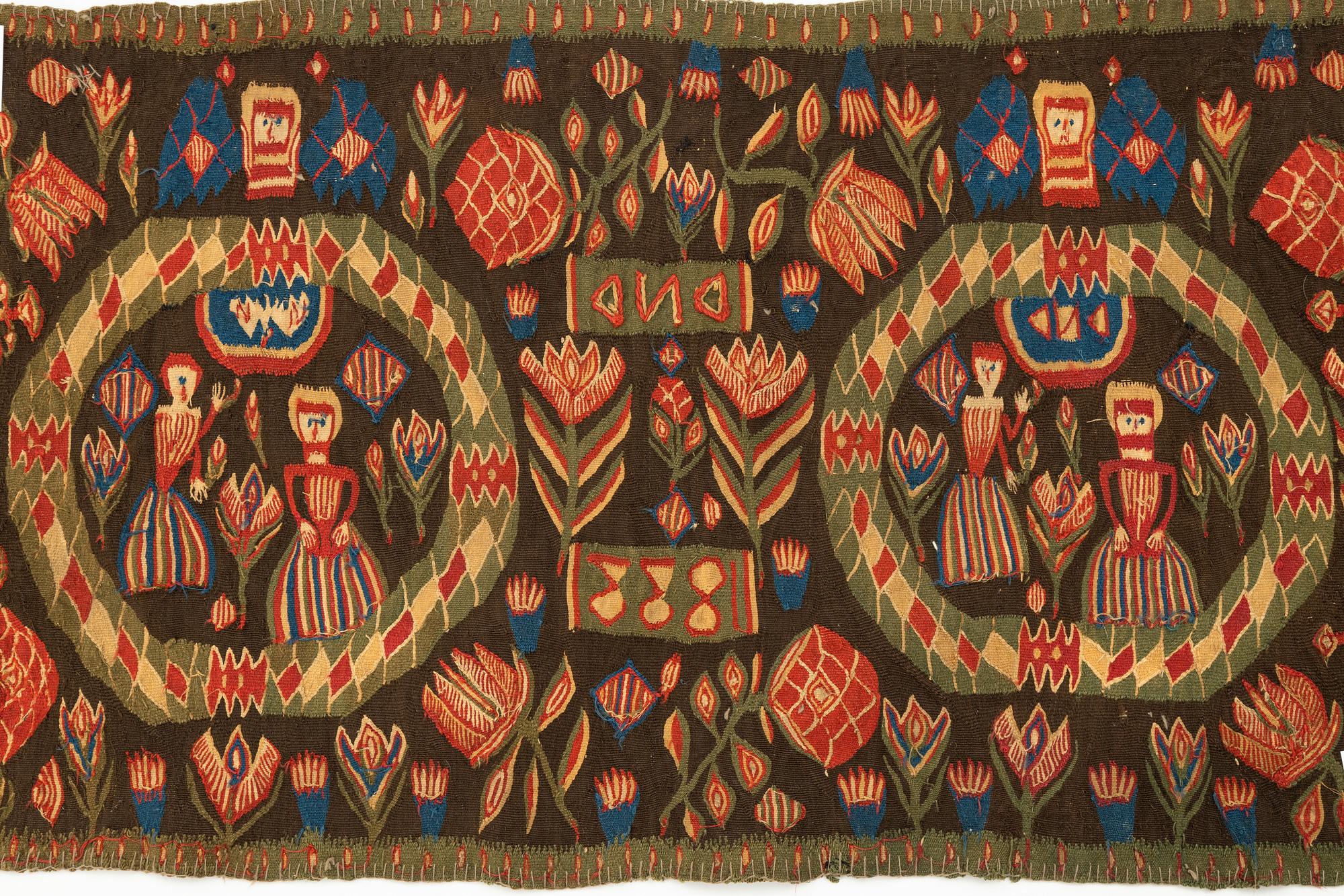 A carriage cushion, "the Annunciation", tapestry weave, ca 103 x 51 cm, south western Scania (Sweden), 1833.
