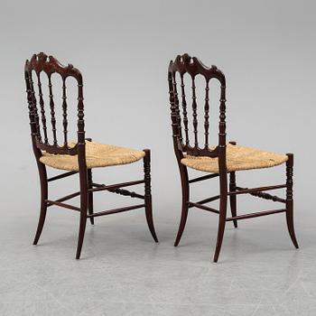 A pair of Chiavari chairs.