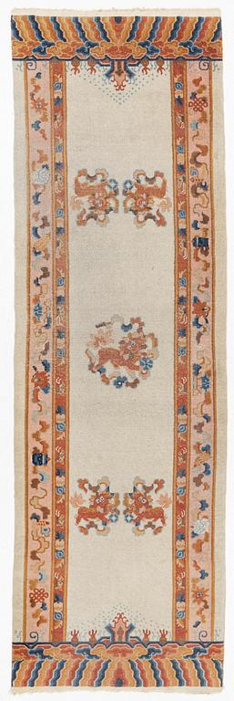 An antique / semi antique runner carpet, China, ca 300 x 96 cm.
