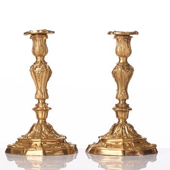 A pair of French Louis XV mid 18th century gilt bronze candlesticks.