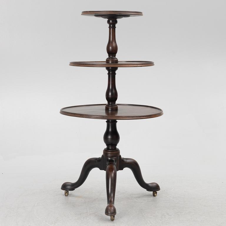 A mahogany three-tier table, England, circa 1900.