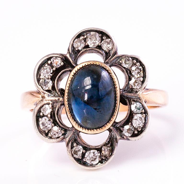 A 10-11K gold ring with a cabochon cut sapphire and old cut diamonds ca. 0.35 ct in total.