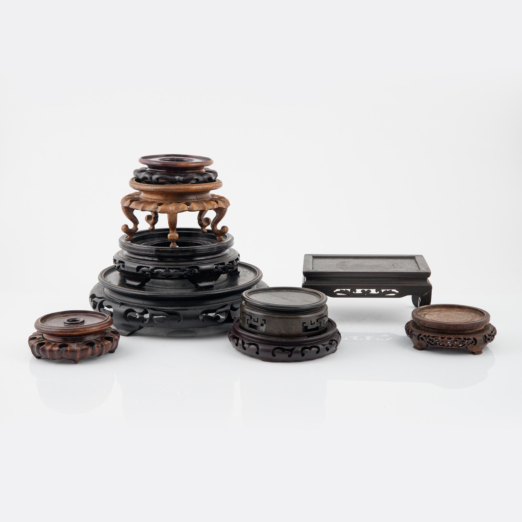 A group of nine hardwood stands, late Qing dynasty and 20th Century.