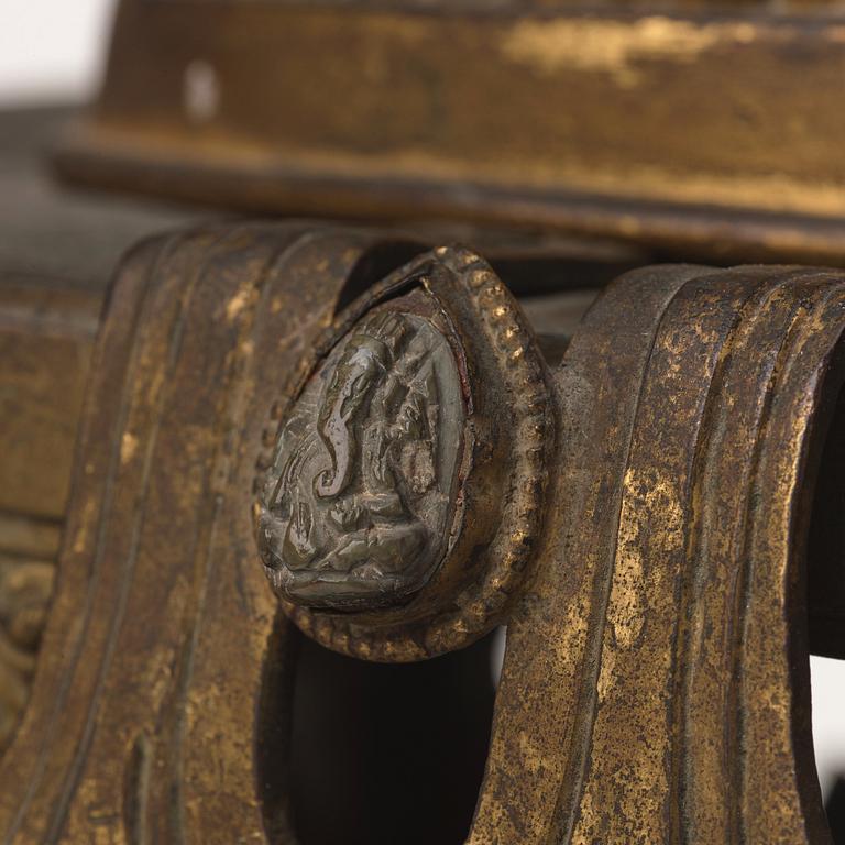 A large Nepalese gilt bronze buddha on a throne with mandorla, 18/19th Century.