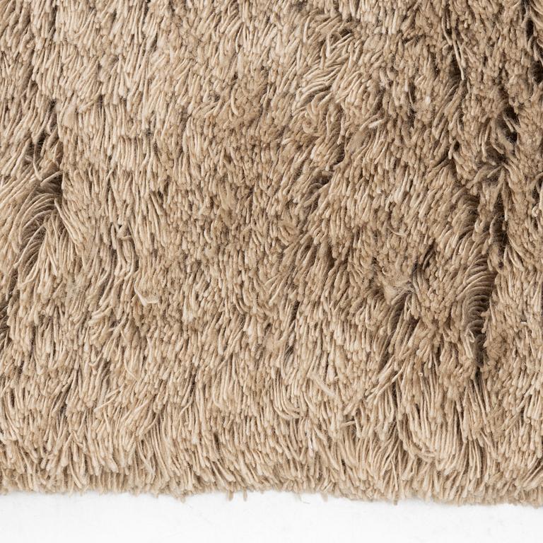 A monochrome carpet, 'Fallingwater - Mocha' by Layered, ca 400 x 300 cm.