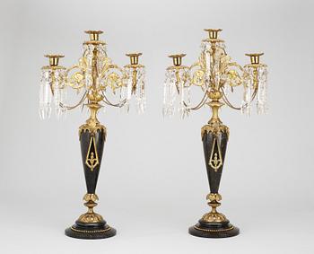 199. A pair of late 19th century black marble and gilt bronze kandelabra.