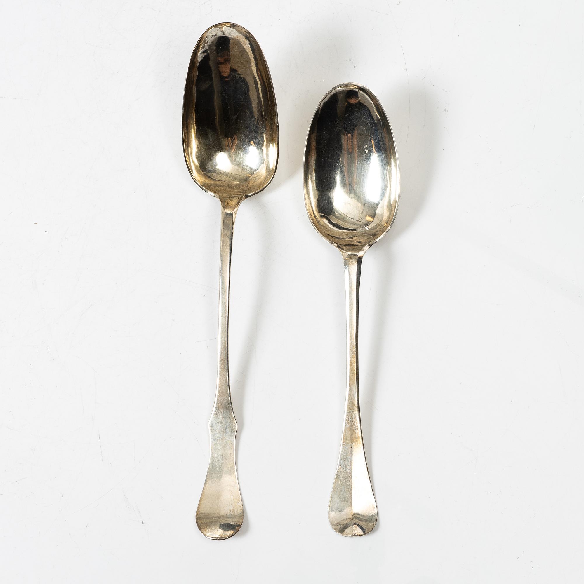 Two silver serving spoons with pseudo-marks, around the year 1900.