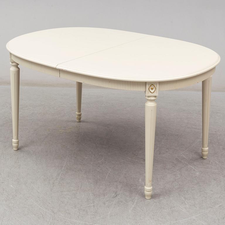 A dining table and 4 chairs, second half of the 20th century. 2 leaves included.