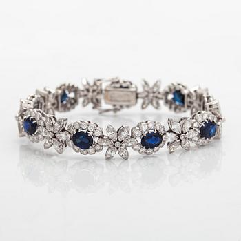 A platinum bracelet, set with oval faceted sapphires and brilliant-, marquise-, and single-cut diamonds.