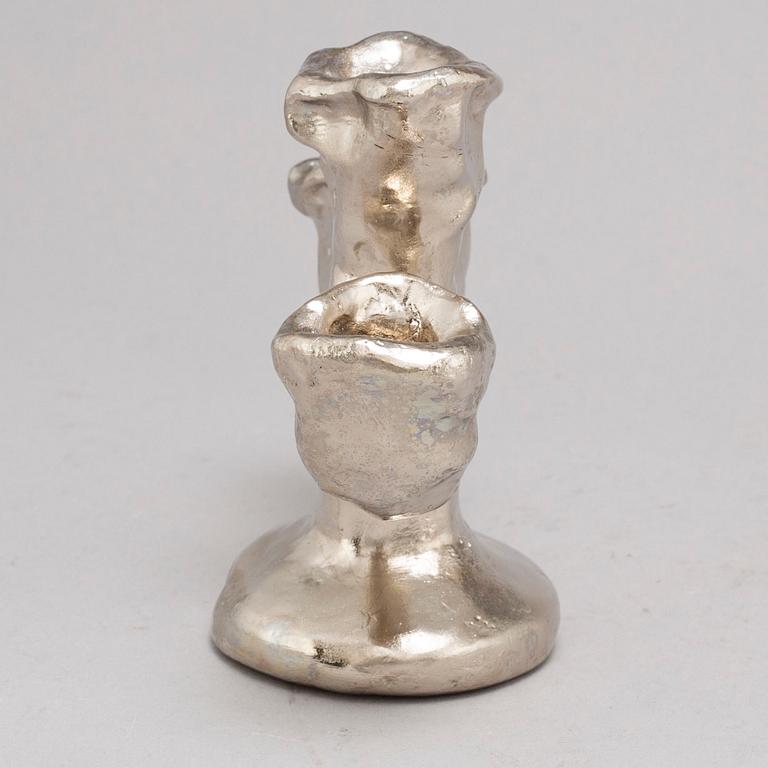 DAN WOLGERS, a silvergilt bronze candle stick, signed.