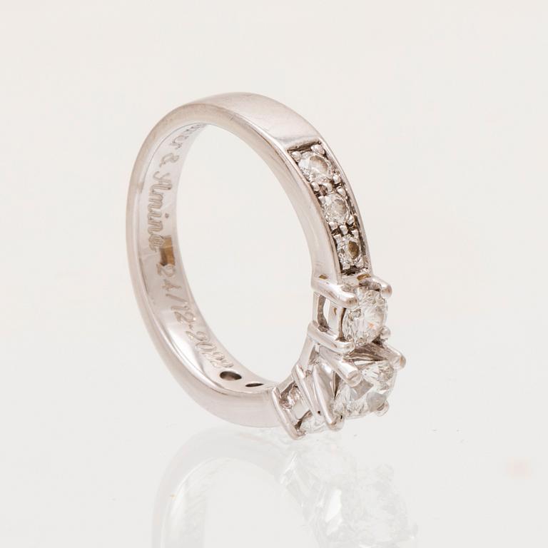 An 18K white gold ring set with round brilliant cut diamonds.
