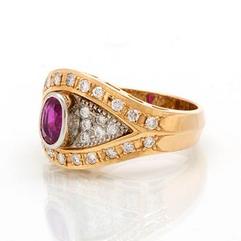 An 18K gold and platinum ring with diamonds and a ruby.