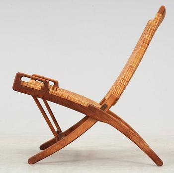 A Hans J Wegner oak and rattan folding chair, by Johannes Hansen, Denmark.