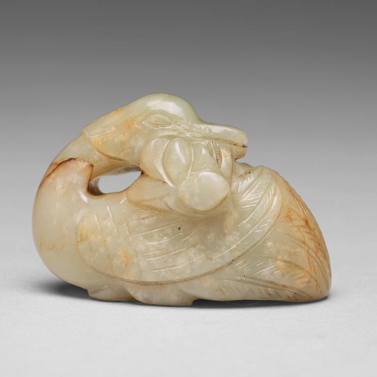 A Chinese nephrite figure of a duck with a lotus bud.