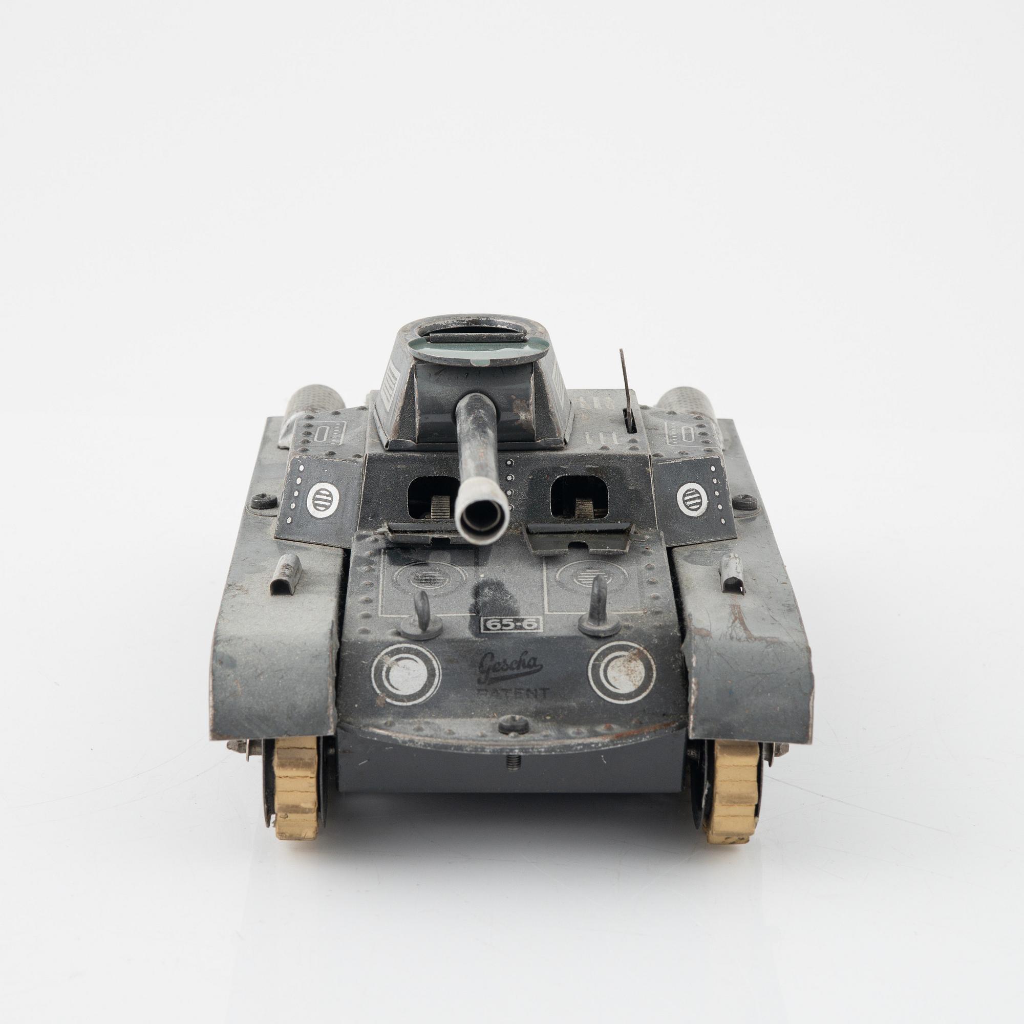 Three tin toys including a Gescha tank, Germany, mid 20th century.