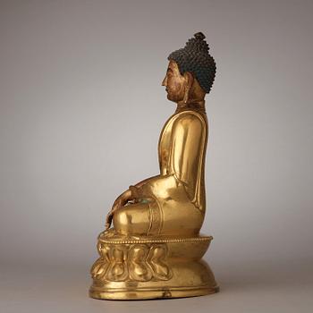 A finely cast Tibeto-Chinese gilt bronze figure of Shakyamuni Buddha, Qing dynasty, circa 1800.