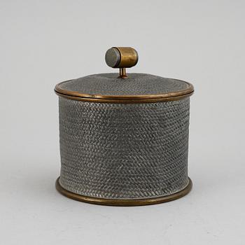 a pewter and brass jar with cover by Svenskt Tenn, Stockholm 1936.