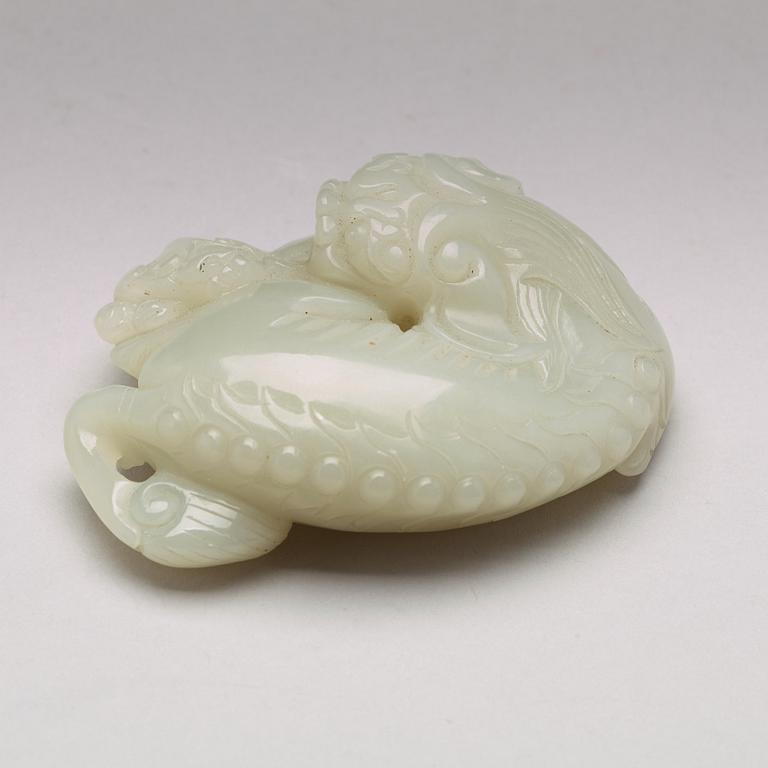 A Chinese nephrite figure of a reclining buddhist lion and its cub, presumably circa 1900.