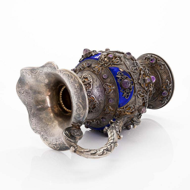 A parcel-gilt silver jug with enamel, and cabochon cut amethysts. First half of the 20th century.