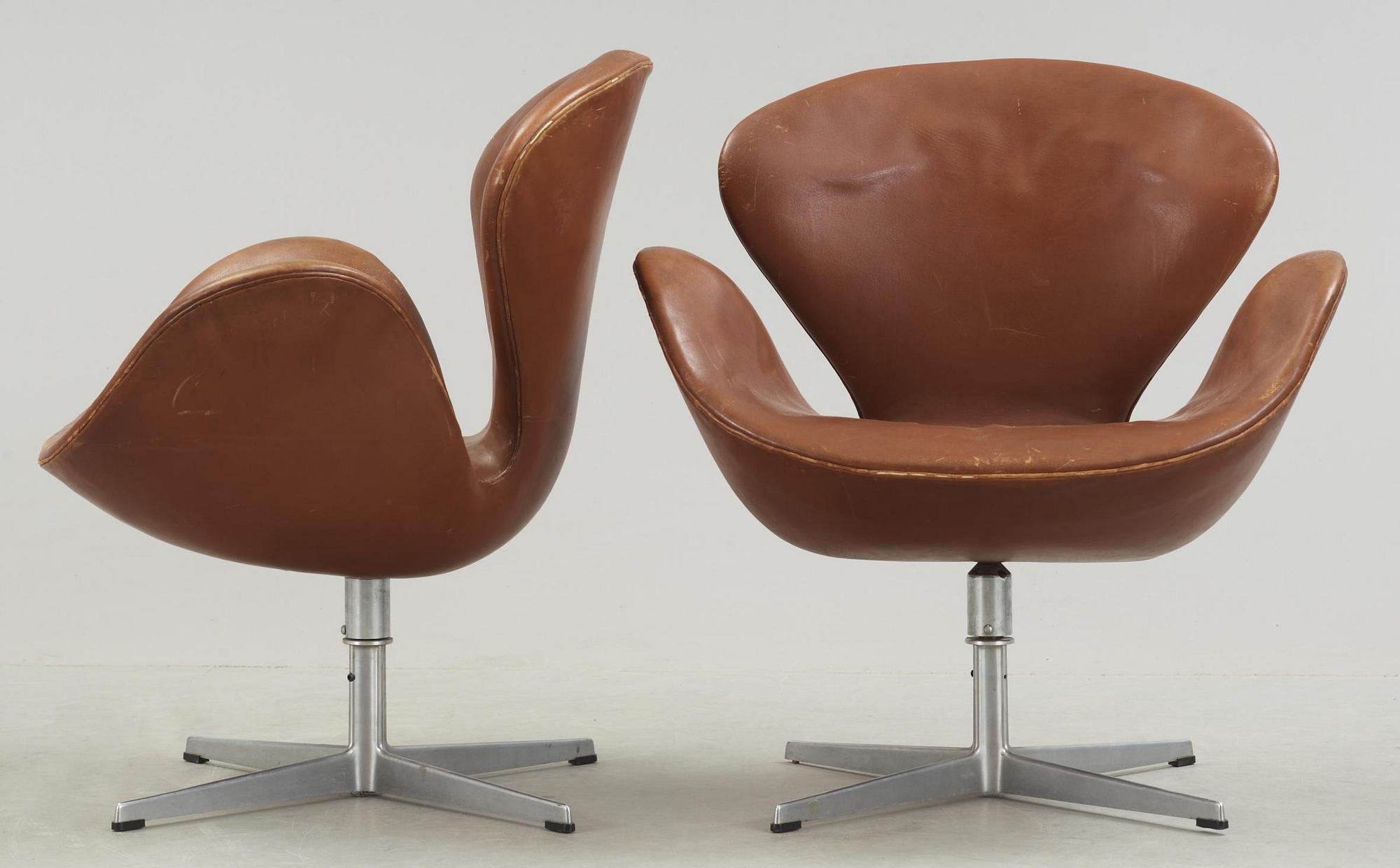 A pair of Arne Jacobsen brown leather 'Swan' chairs, Fritz Hansen, Denmark 1972.