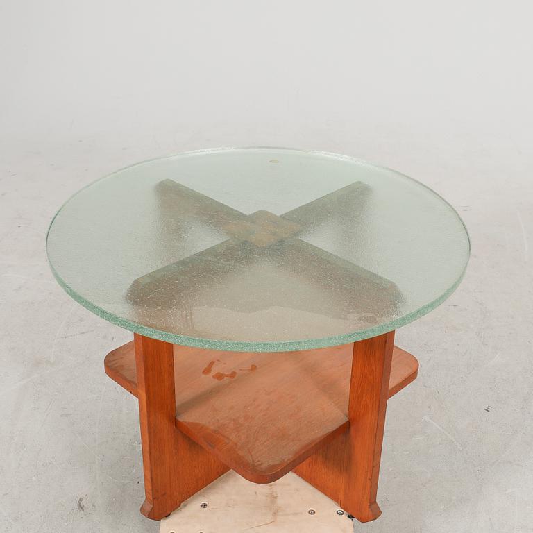 A 1940s wood and glass coffee table.
