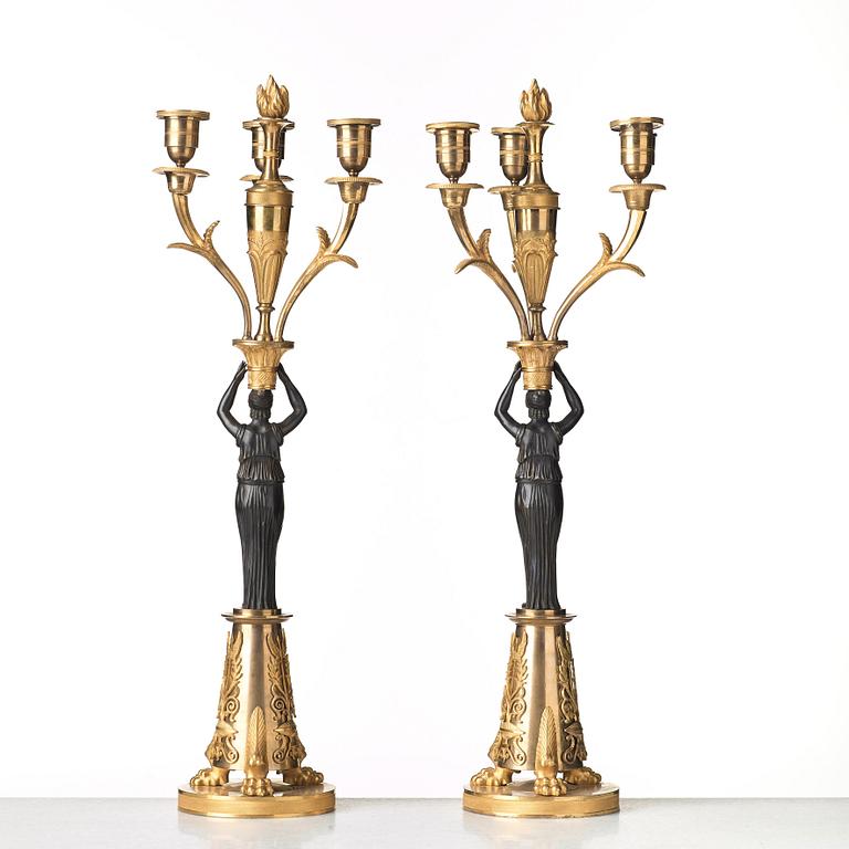 A pair of French Empire early 19th century three-light candelabra.