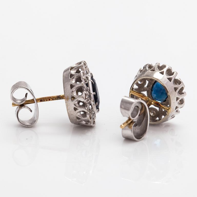 A pair pf 18K white gold and 14K gold earrings with diamonds ca. 0.24 ct in total and sapphires. TIllander, Helsinki.