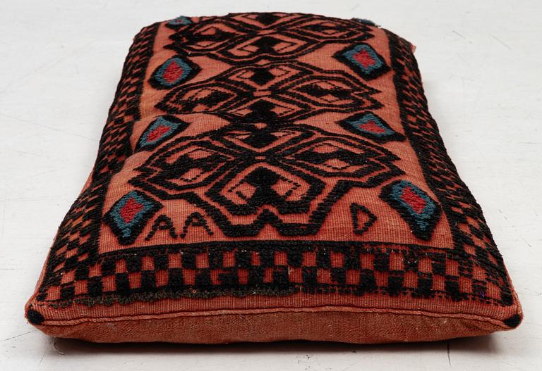 A carriage cushion, knotted pile in relief, ca 106 x 47, southwest of Scania, Sweden, circa 1800.