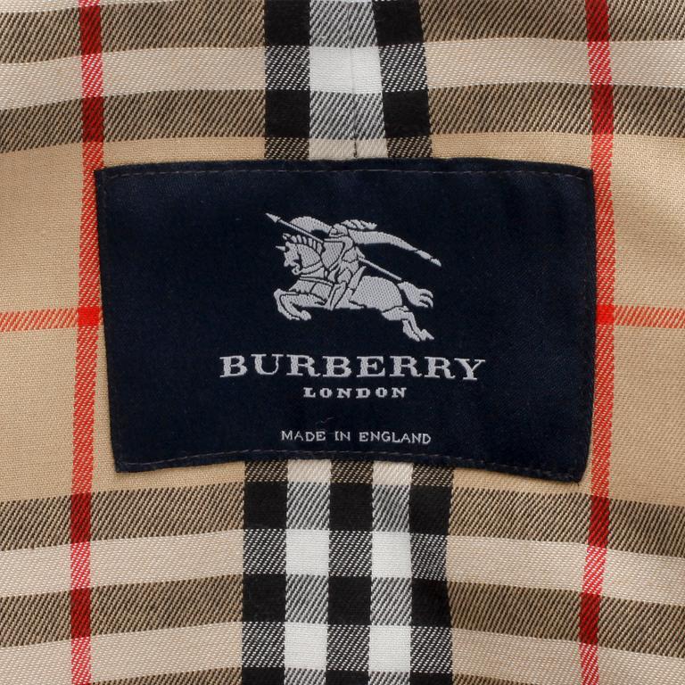 BURBERRY, a beige cotton blend trench coat and a shawl.