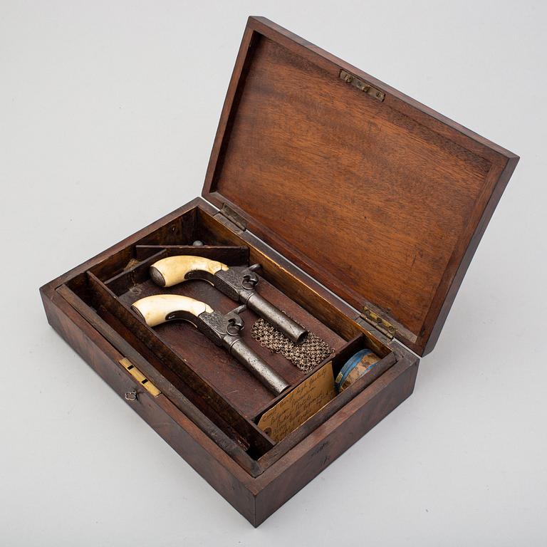 A mid 19th century Belgian rifled percussion pistols with ivory butts in a case.