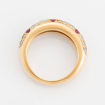 An 18K gold Cartier ring set with round brilliant-cut diamonds and rubies.