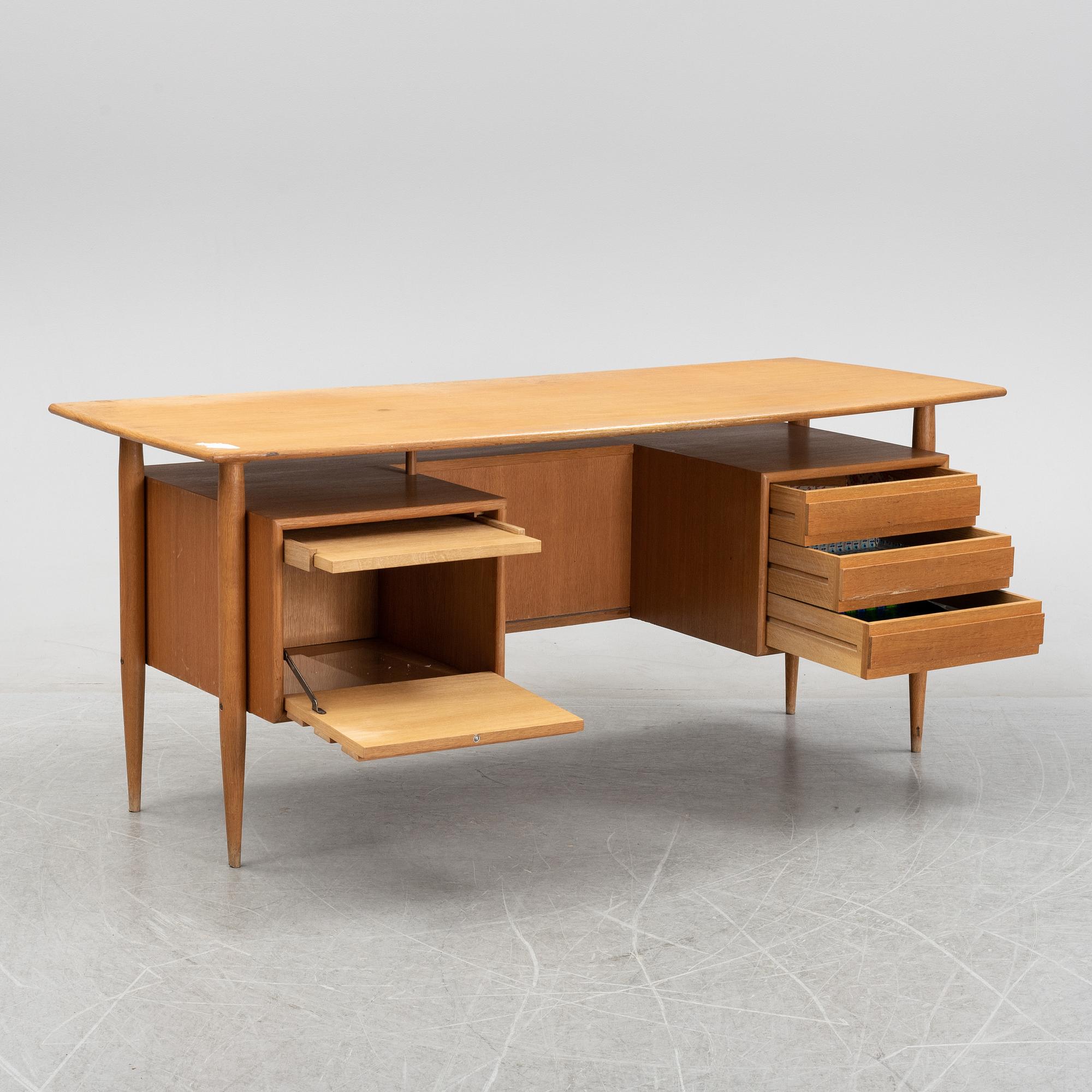 A teak veneered writing desk, 1950's/60's.