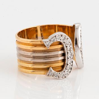 A Cartier "Double C" ring in 18K tri color gold set with round brilliant-cut diamonds.