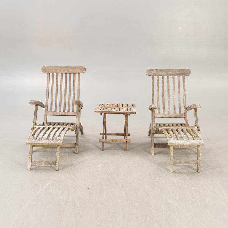 A pair of teak deck chairs and table later part of the 20th century.