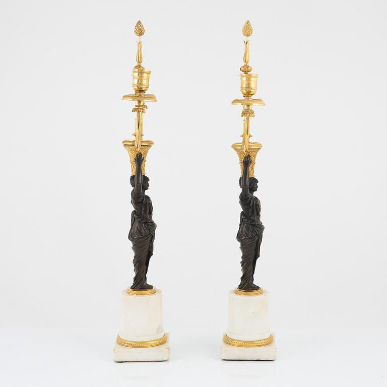 A pair of French Louis XVI ormolu, marble, and patinated bronze two-branch candelabra, late 18th century.