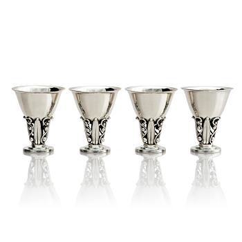 527. Evald Nielsen, four sterling silver beakers/cups on a foot, Denmark 20th century.