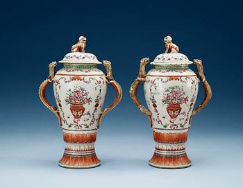 1518. A pair of famille rose vases with covers, Qing dynasty, Qianlong (1736-95).