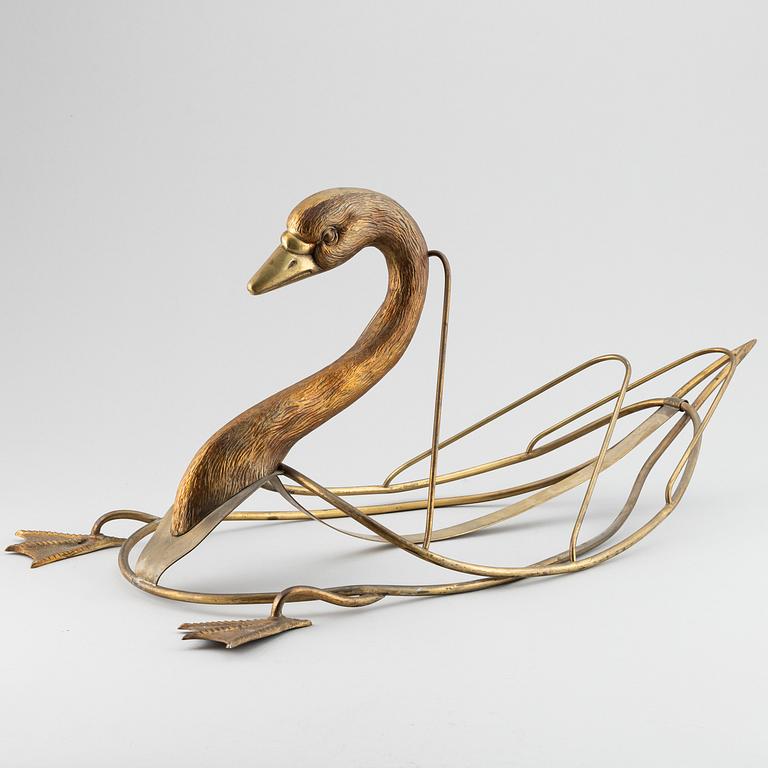 A 20th century grass newspaper stand in the shape of a swan.