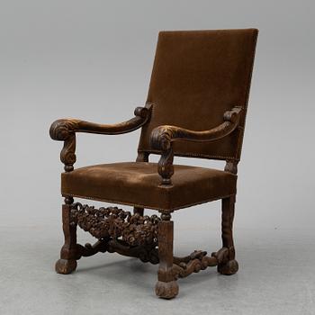 A carved baroque style armchair from around 1900.