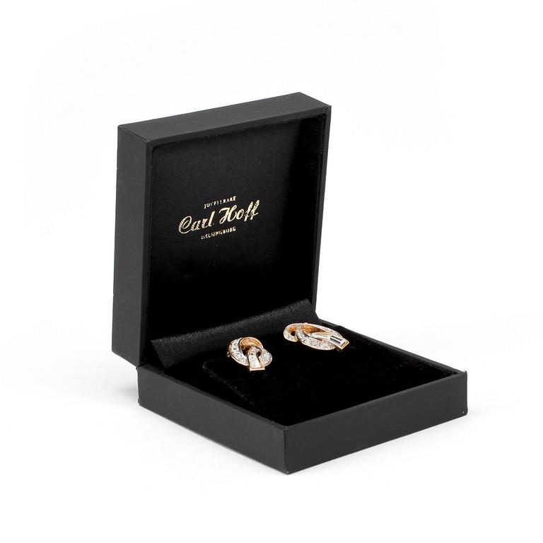 NINA RICCI, a pair of gold colored and decorative stone embellished clip earrings.