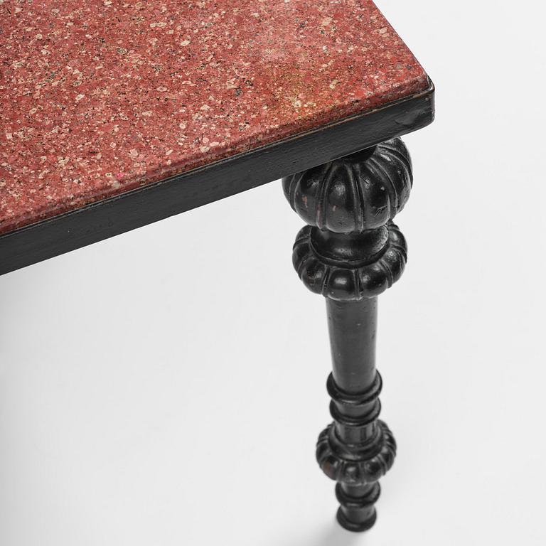 A table with granite stone top from Älvdalen, first part 19th century on a later metal stand.