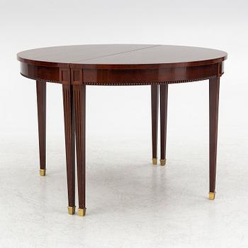 An Empire style dining table and ten chairs, second half of the 20th Century.