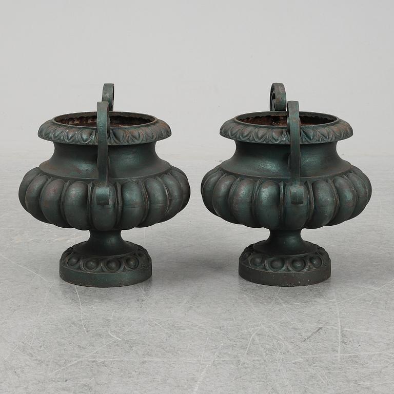 A 20th Century pair of cast iron flower pots.